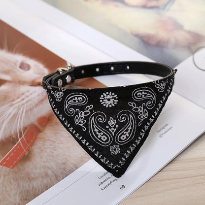 Bandana triangulaire pour chien noir à motifs, attache réglable avec anneau métallique.