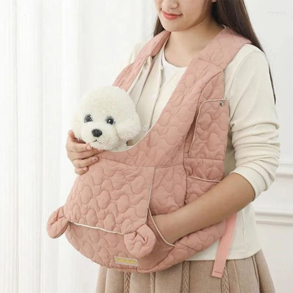 Sac de transport pour petit chien rose matelassé, fermeture à cordon et poche.